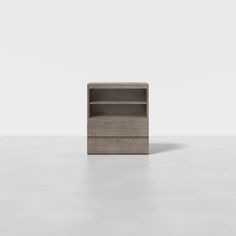 an empty bookcase sitting on top of a white floor