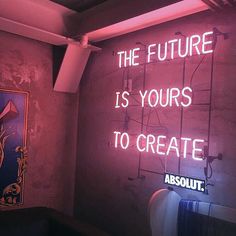 a neon sign that reads, the future is yours to create absolut '