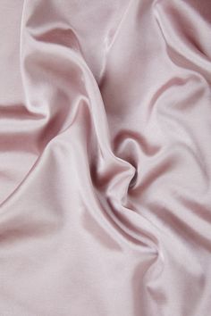 a close up view of a pink satin fabric