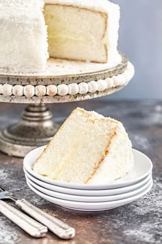 a slice of white cake sitting on top of plates