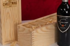 a bottle of wine sitting next to two wooden boxes