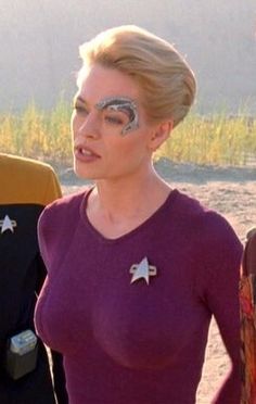 two women in costumes standing next to each other with their faces painted like star trek characters