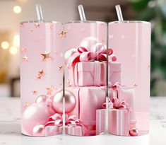 pink christmas gifts are stacked on top of each other with gold stars and ornaments in the background