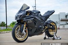 a black and gold motorcycle parked in a parking lot