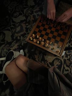 two people sitting on the floor playing chess