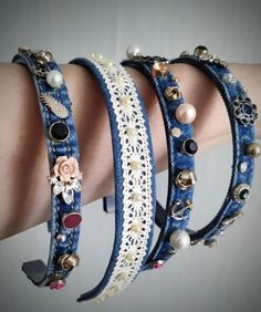 two bracelets with pearls and other beads on the wrist, one has a flower