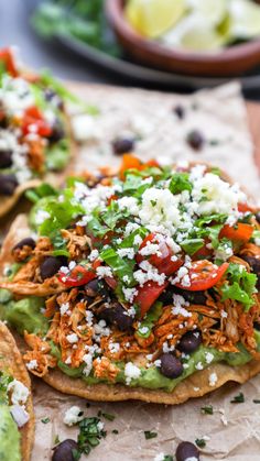 two tortillas topped with shredded cheese, black beans and vegtables