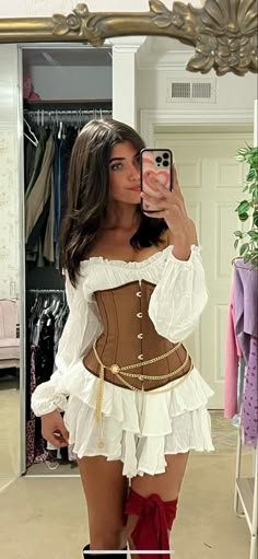 a woman taking a selfie in front of a mirror wearing a corset