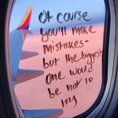 an airplane window with writing on it and the view from inside, looking out into the sky