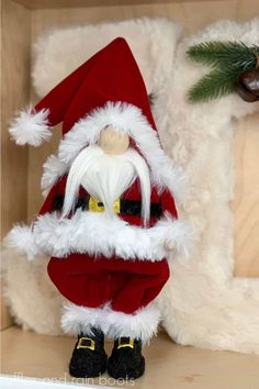 a santa clause figurine sitting on top of a shelf