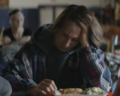 a man sitting at a table eating food