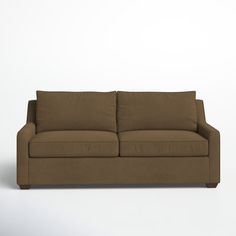 a brown couch sitting on top of a white floor