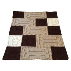 a crocheted blanket with brown and white squares