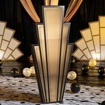 an art deco table lamp in the middle of a room with black and white decorations