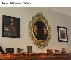 there is a fireplace with pictures on the wall and candles in front of it that are lit up