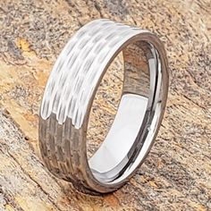 a wedding band that has been made with wood and silver inlays on it