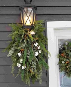 two wreaths hanging from the side of a house