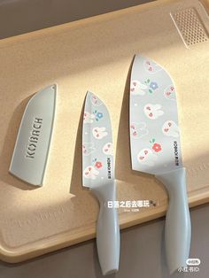 three knives on a cutting board with the words yoshi written in japanese and english