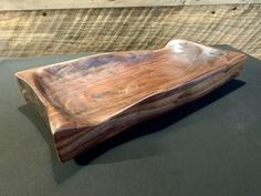 a wooden bowl sitting on top of a table