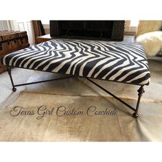 a zebra print ottoman sitting on top of a rug