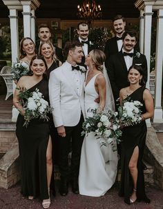 a group of people standing next to each other in front of a building with columns