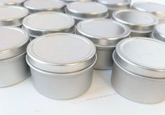 Overstock of materials. Lot of 1 oz silver deep push top tins for DIY lip balms, solid perfumes, pillbox, salves, crafts or light-sensitive materials. Size: 1 ounce capacity and 1 1/2" diameter x 1" H Material: tin plate Quantity: 17 pieces