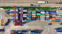 an aerial view of shipping containers and trucks