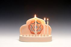 a candle holder with three lit candles in it