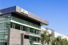 an office building with the word aom written on it's front and side