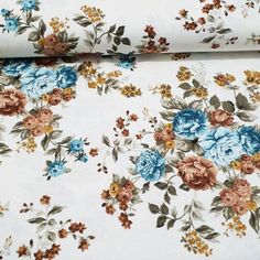 an image of a flowered fabric with blue and orange flowers on it's side