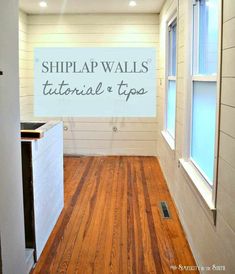 an empty room with a sign that says shiplap walls and a wood floor