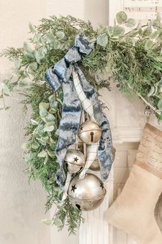 a christmas wreath with ornaments hanging from it