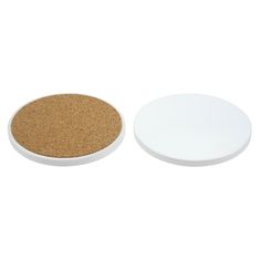 two white plates sitting next to each other on a white surface with cork in the middle