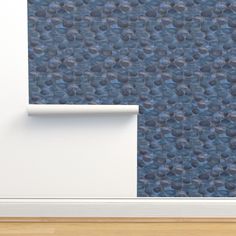 a blue wallpaper with circles on it and a white door frame in front of it