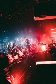 a woman standing on top of a stage in front of a crowd