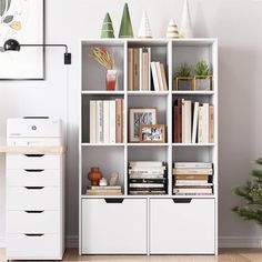 a white bookcase filled with lots of books