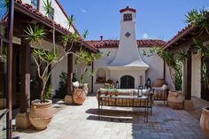 an outdoor patio with seating and potted plants