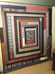 a quilt hanging on the wall in a room