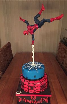 a spiderman cake on top of a wooden table