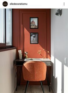 an orange chair sitting in front of a desk with a lamp on top of it