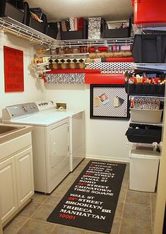 a washer and dryer in a small room with lots of storage on the wall