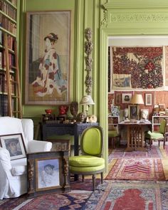 a living room filled with furniture and lots of bookshelves on top of it