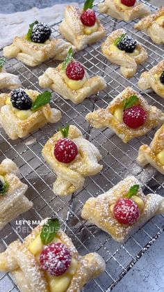 small pastries with raspberries and mint leaves on a cooling rack for baking