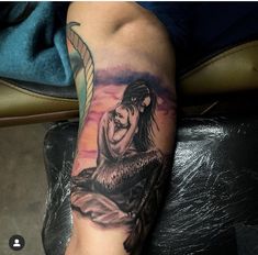 a woman's arm with a mermaid tattoo on it