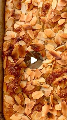 a square pizza with almonds on top in a pan, ready to be eaten