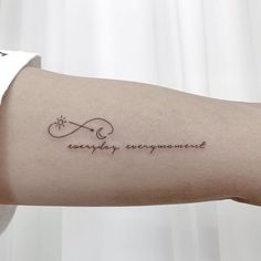 a woman's arm with a tattoo that reads, everyday enjoyment