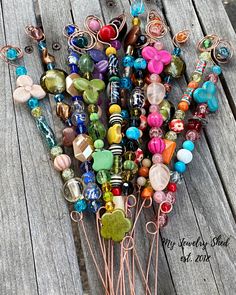 a bunch of different colored glass beads on a wooden table