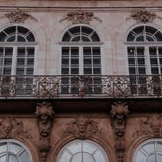 an old building with ornate windows and balconies