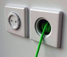 a green cable is plugged into an electrical outlet