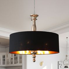 a chandelier hanging from the ceiling in a kitchen